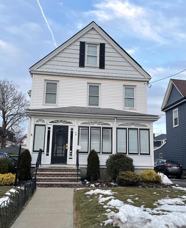 american foursquare style home featuring entry steps and fence