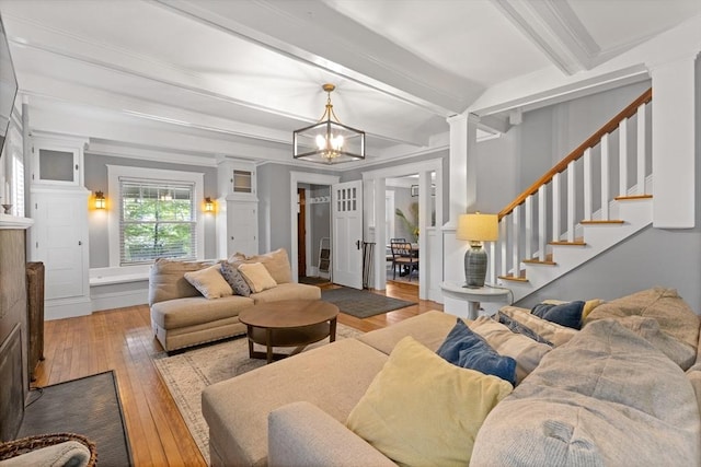 20 Saint Elmo Rd, Worcester, MA 01602 - living area featuring hardwood / wood-style floors, ornate columns, a chandelier, beam ceiling, and stairs