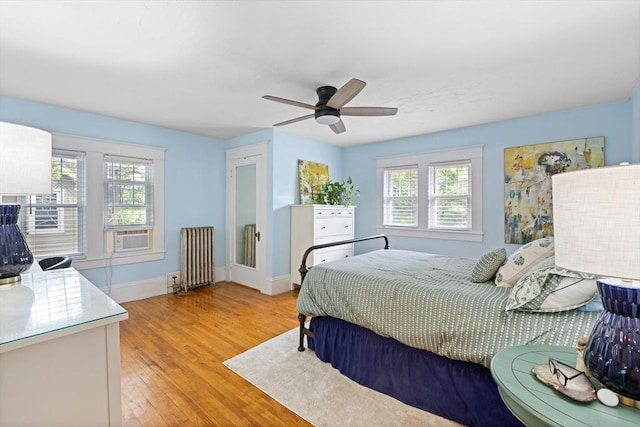 20 Saint Elmo Rd, Worcester, MA 01602 - bedroom featuring radiator, light wood-style floors, baseboards, ceiling fan, and cooling unit