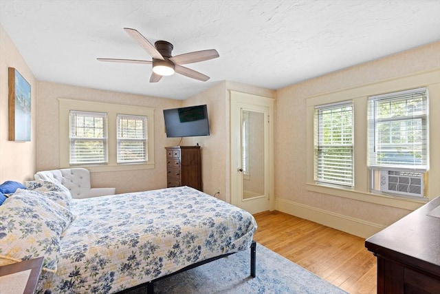 20 Saint Elmo Rd, Worcester, MA 01602 - bedroom with light wood-type flooring, cooling unit, baseboards, ceiling fan, and a textured ceiling