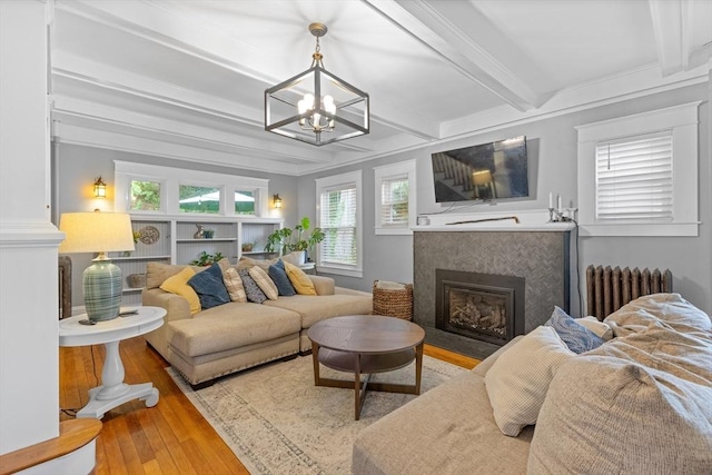 20 Saint Elmo Rd, Worcester, MA 01602 - living room featuring radiator, a chandelier, a fireplace, wood-type flooring, and beam ceiling