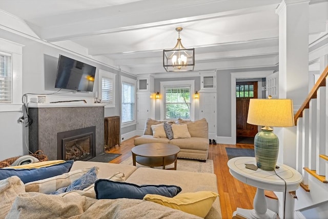 20 Saint Elmo Rd, Worcester, MA 01602 - living area with wood finished floors, a chandelier, beam ceiling, stairs, and a tile fireplace
