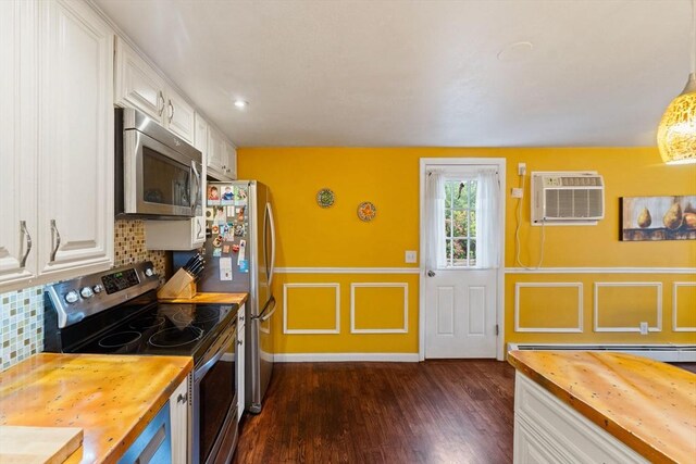 44 Drexel St, Worcester, MA 01602 - kitchen with wooden counters, stainless steel appliances, white cabinets, an AC wall unit, and a decorative wall