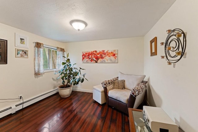 44 Drexel St, Worcester, MA 01602 - living area with a baseboard heating unit, wood finished floors, baseboards, and a textured ceiling