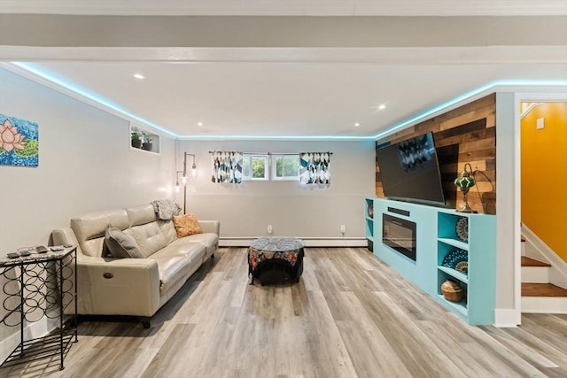 44 Drexel St, Worcester, MA 01602 - living area featuring wood finished floors, a baseboard radiator, a glass covered fireplace, recessed lighting, and stairs