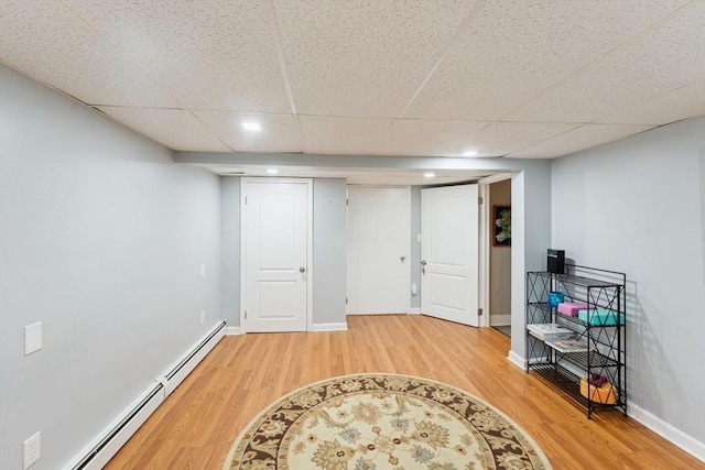 44 Drexel St, Worcester, MA 01602 - finished below grade area with light wood-type flooring, a baseboard radiator, recessed lighting, a paneled ceiling, and baseboards