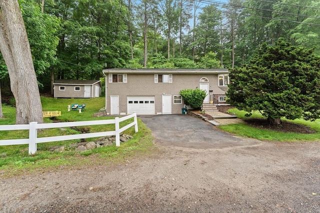 44 Drexel St, Worcester, MA 01602 - split foyer home featuring asphalt driveway, an attached garage, and view of wooded area