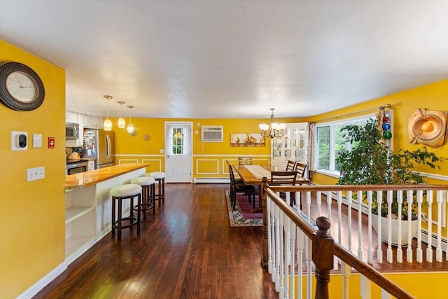 44 Drexel St, Worcester, MA 01602 - dining space featuring a chandelier, dark wood-style flooring, healthy amount of natural light, a wainscoted wall, and a baseboard heating unit