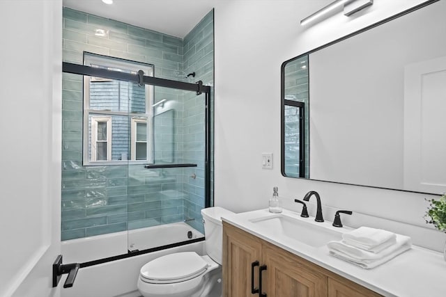 bathroom with bath / shower combo with glass door, vanity, and toilet