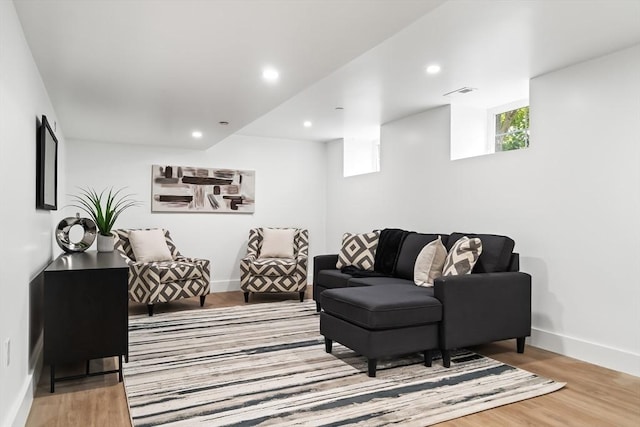 living room featuring baseboards, recessed lighting, wood finished floors, and visible vents