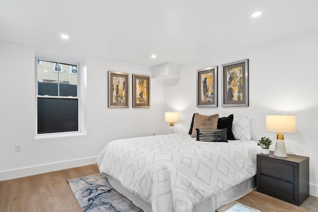 bedroom with recessed lighting, baseboards, and wood finished floors