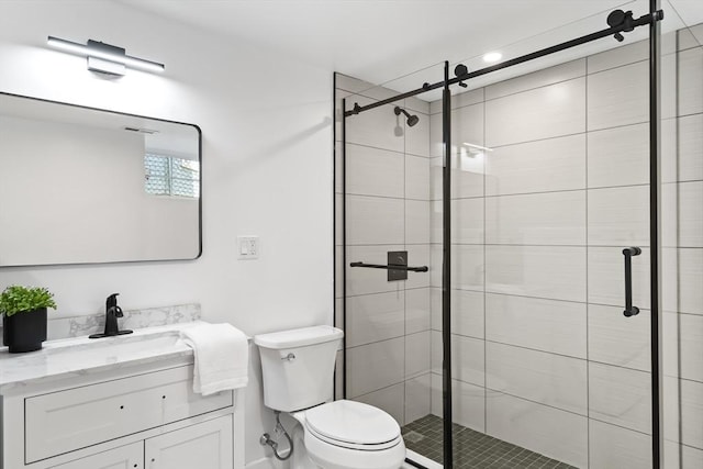 bathroom featuring vanity, a stall shower, and toilet
