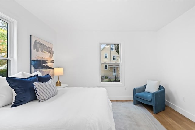 bedroom featuring baseboards and wood finished floors