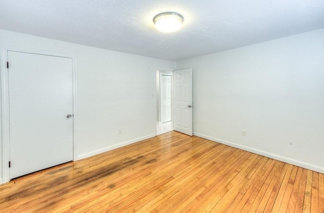 unfurnished room with light wood-type flooring