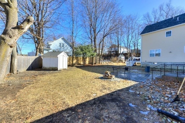 view of yard with a fire pit and a storage unit