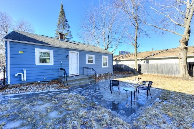 view of snow covered rear of property