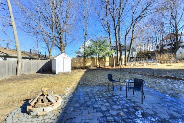 view of yard with an outdoor fire pit, a patio, and a shed