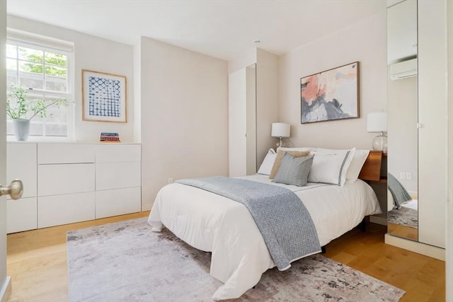 65 Glen Rd Unit H4, Brookline, MA 02445 - bedroom featuring a wall mounted AC and wood finished floors