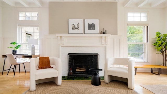 65 Glen Rd Unit H4, Brookline, MA 02445 - living area with light wood-style flooring, healthy amount of natural light, beam ceiling, and a tiled fireplace