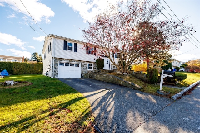 split foyer home with a garage and a front lawn