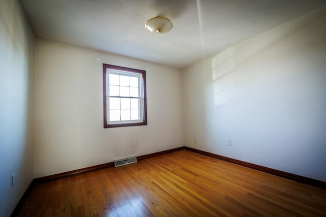 spare room featuring hardwood / wood-style floors