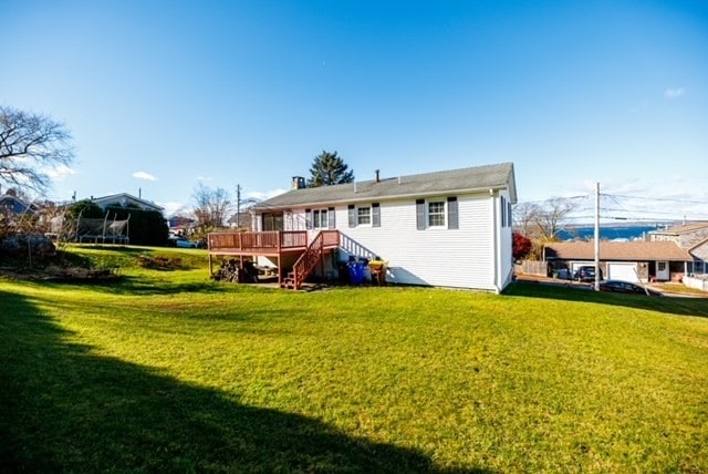 back of house with a yard and a wooden deck