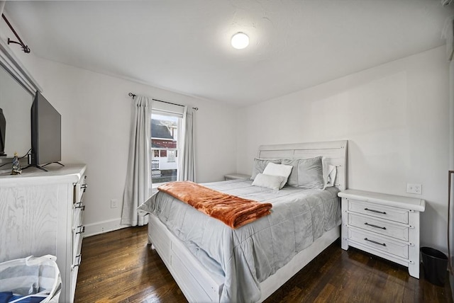 bedroom with dark hardwood / wood-style floors