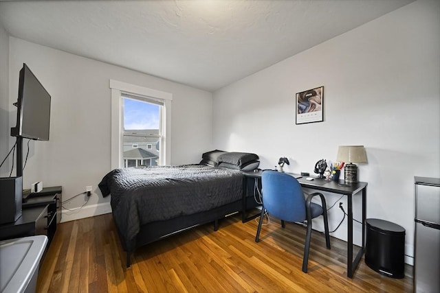 bedroom with hardwood / wood-style floors