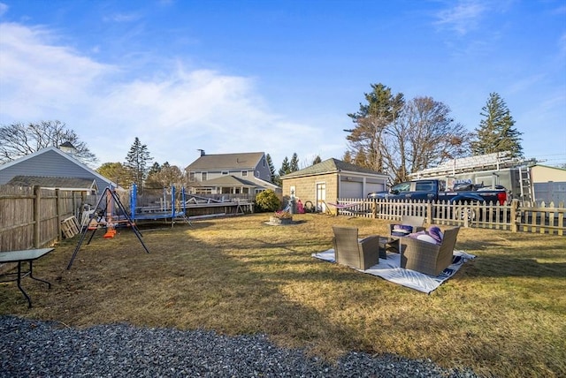 view of yard featuring an outdoor structure and a trampoline