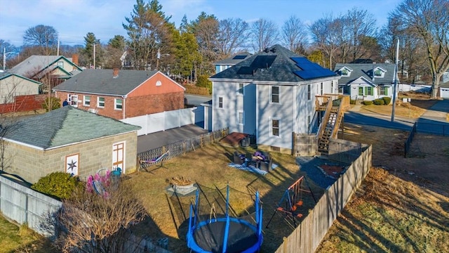 rear view of house featuring a trampoline