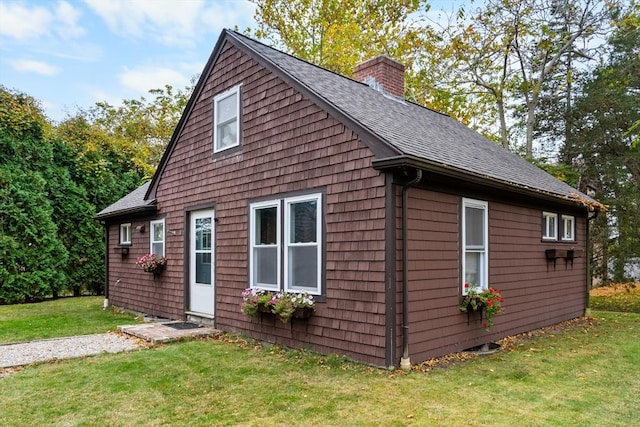 view of property exterior with a yard