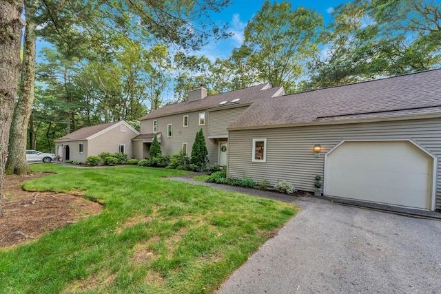 10 Fox Holw Unit 10, Wayland, MA 01778 - view of front of house with a chimney, a front yard, asphalt driveway, a garage, and roof with shingles