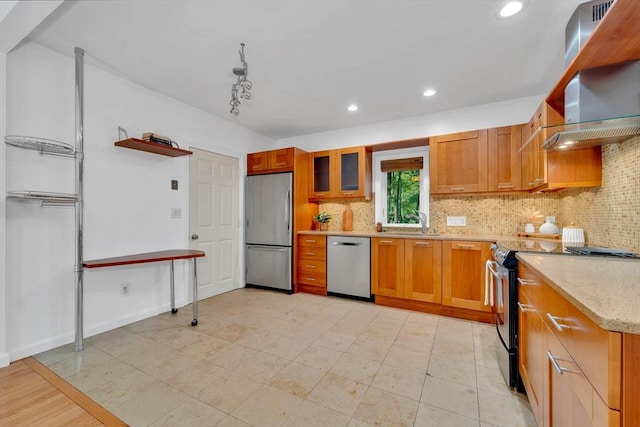 10 Fox Holw Unit 10, Wayland, MA 01778 - kitchen with stainless steel appliances, tasteful backsplash, brown cabinetry, wall chimney range hood, and recessed lighting