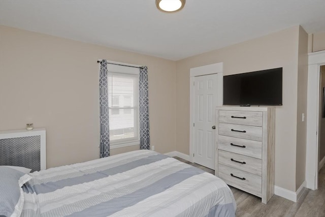 bedroom featuring baseboards and light wood-style flooring