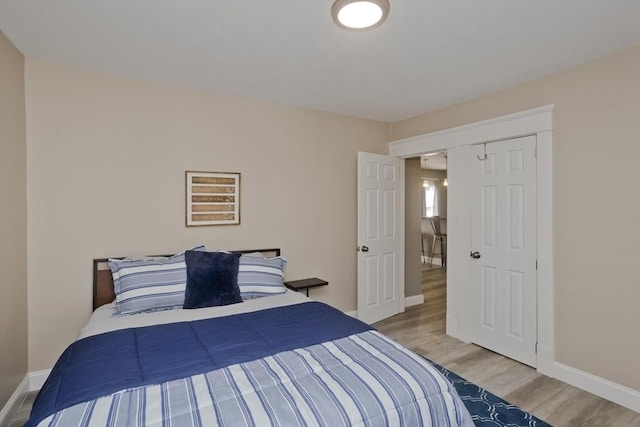 bedroom featuring baseboards and wood finished floors