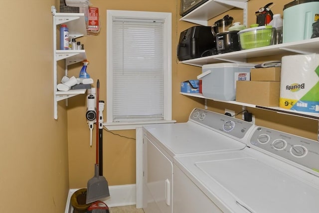 clothes washing area featuring washing machine and clothes dryer and laundry area