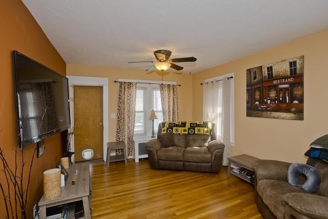 living area with ceiling fan and wood finished floors
