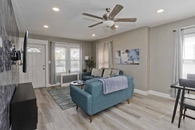 living room with ceiling fan, light wood-style floors, radiator, recessed lighting, and baseboards