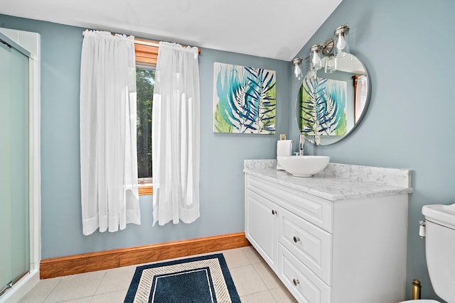 bathroom with vanity, tile patterned flooring, toilet, and an enclosed shower