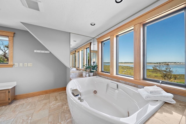 bathroom with a water view and a bathing tub