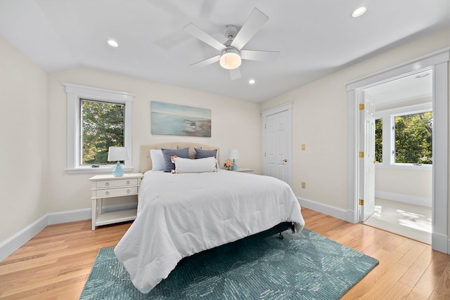 bedroom featuring ceiling fan, lofted ceiling, and light hardwood / wood-style floors