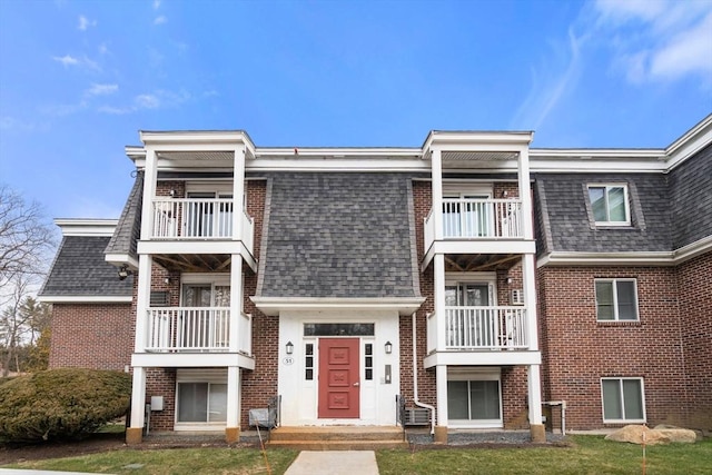 exterior space with a front lawn and a balcony