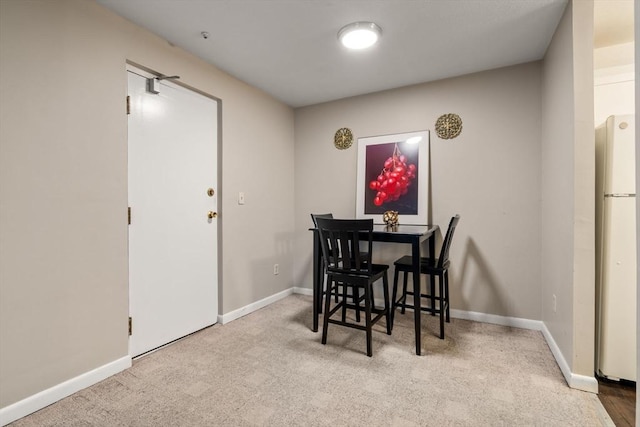 dining area featuring light colored carpet