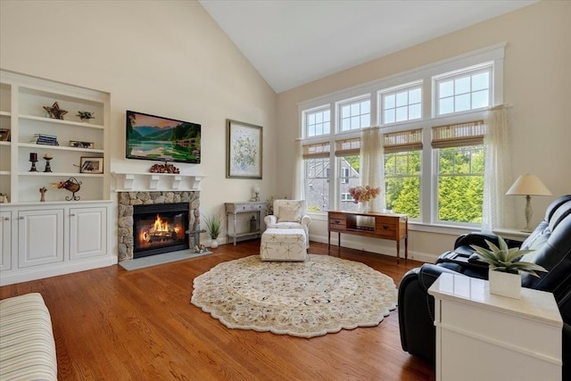 101 Pheasant Hill Cir, Barnstable, MA 02635 - living area featuring a stone fireplace, wood finished floors, and high vaulted ceiling