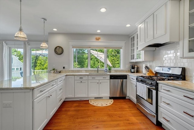 101 Pheasant Hill Cir, Barnstable, MA 02635 - kitchen featuring appliances with stainless steel finishes, a peninsula, white cabinets, tasteful backsplash, and recessed lighting