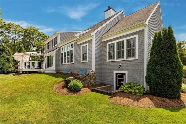 101 Pheasant Hill Cir, Barnstable, MA 02635 - rear view of property featuring a wooden deck, a lawn, a chimney, and a shingled roof