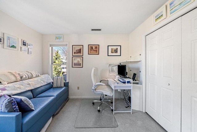 office space with visible vents, light carpet, and baseboards