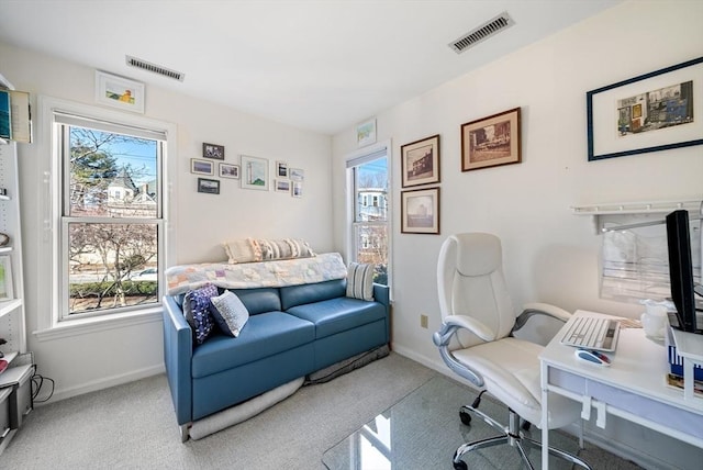 office area featuring visible vents, a wealth of natural light, and carpet floors