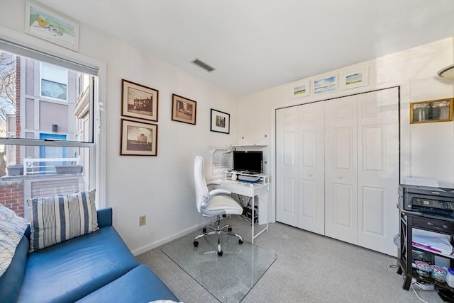 carpeted home office with visible vents and baseboards