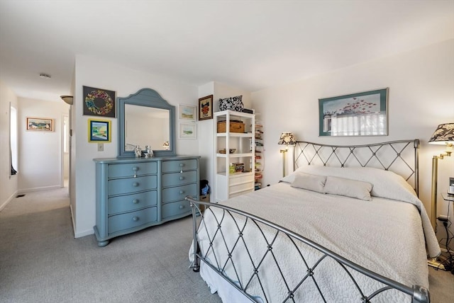 carpeted bedroom featuring baseboards